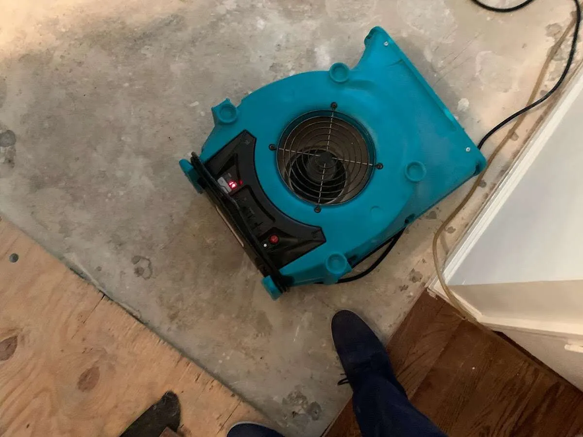 Air mover drying subfloor during Commercial Water Damage Restoration in Graham